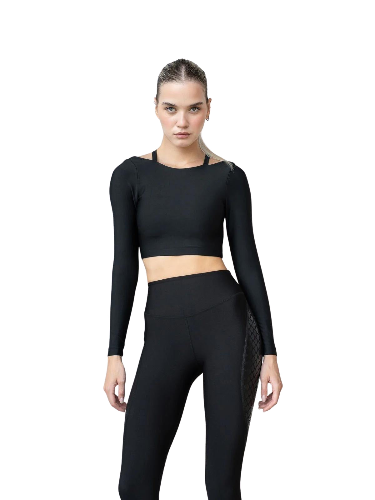 Eine Person trägt Lisminas 086 Parisis Langarm-Top in Schwarz und Leggings und nimmt vor einem weißen Hintergrund eine Yoga-Pose ein.